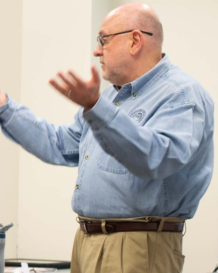 Dr. Tim teaching in a classroom